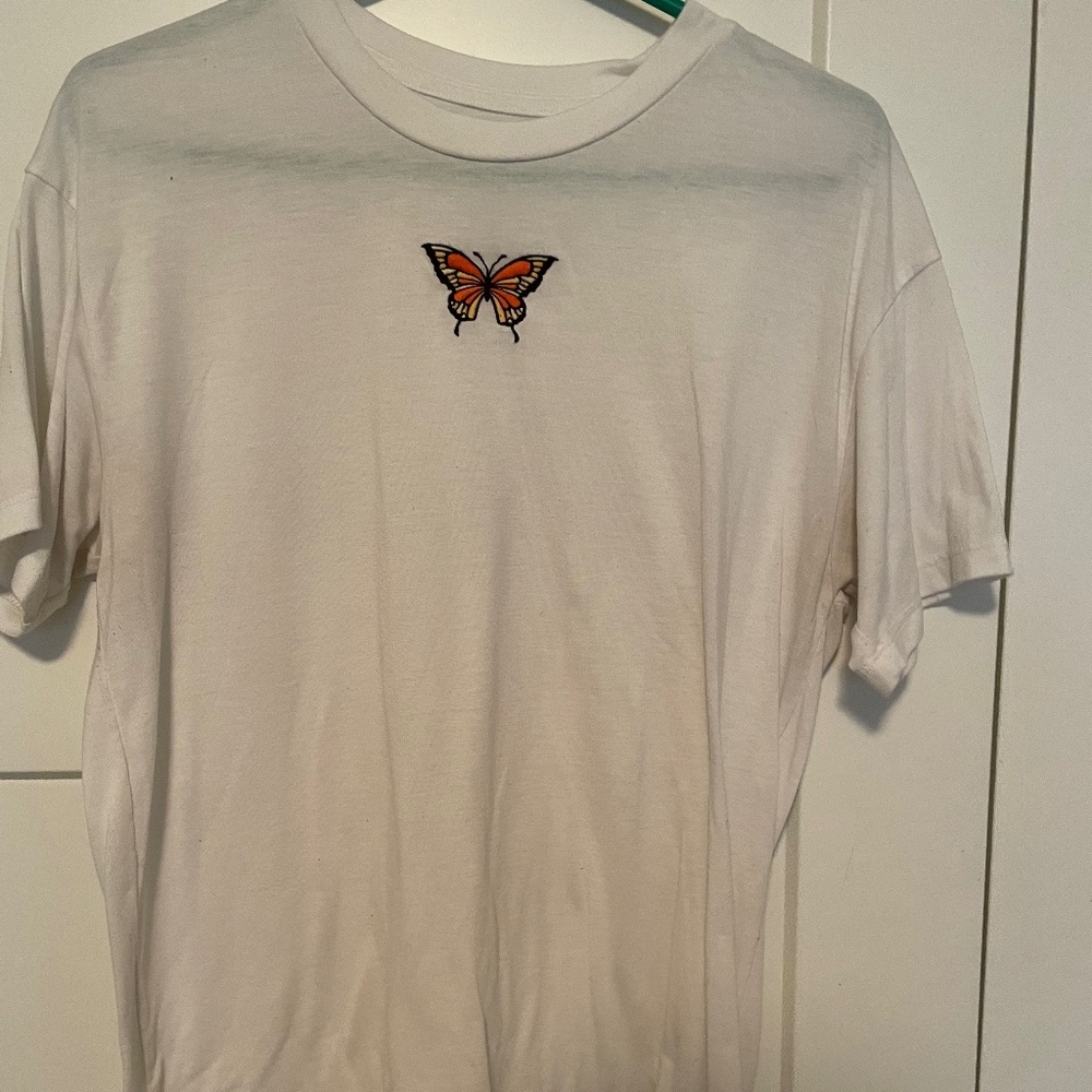 White t-shirt with orange and yellow butterfly